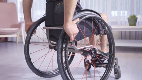 Close-up-of-hands-holding-a-wheelchair.